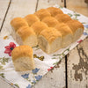 Pack of twelve soft, freshly baked dinner rolls with light golden tops, handcrafted in USA, ideal for Kitchen & Food, Food, Snacks and Sweets, USA Made, Best Sellers, and Promo Eligible collections.