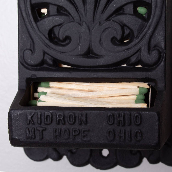 Handcrafted black cast iron wall-mounted matchbox holder with vintage decorative design, made in USA, ideal for Home & Decor, Household Helpers, and Best Sellers collections.