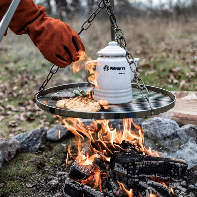 Chromium-plated steel hanging grate suspended by adjustable chains over an open campfire with a white enamel coffee pot, grilled bread, and burger patty, featured in Farm, Garden & Tool, Camping, Best Sellers, and Promo Eligible collections.