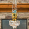 Glass oil lamp with clear base, brass burner, and bright blue flame mantle, part of Lamps & Lighting, Parts and Accessories, Wicks and Mantles, Lamp Burners and Collars, Best Sellers, and Promo Eligible collections.