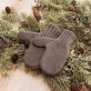 Cozy gray cotton blend mittens joined by a durable string, resting on dried pine and cedar branches with pinecones, ideal for Home & Decor and Holiday Decor collections.