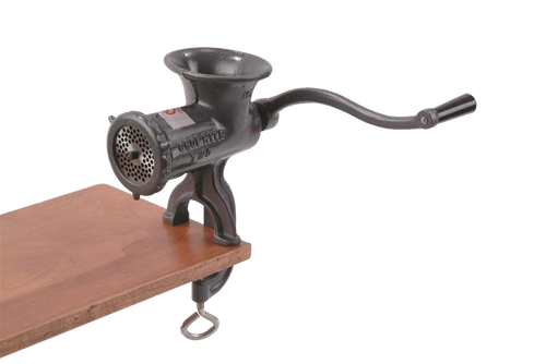 Black clamp-down meat grinder with a long hand crank attached to a wooden surface, featuring a tough Xylon coating and FDA-approved finish, ideal for Kitchen & Food, Specialty Equipment, Butchering Supplies, USA Made, Best Sellers, and Promo Eligible collections.