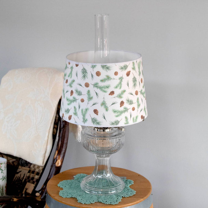 Handcrafted parchment lamp shade featuring festive pine bough and pinecone patterns, designed to softly diffuse light; ideal for Lamps & Lighting, Parts and Accessories, Lamp Shades, Best Sellers, and Promo Eligible collections.