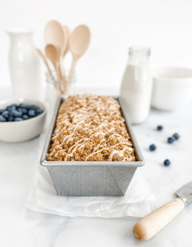 Handcrafted non-stick aluminized steel loaf pan with crumb-topped bread, surrounded by fresh blueberries, milk, wooden utensils, and baking essentials, featured in Kitchen & Food, Bakeware, and Bread Making Supplies collections.