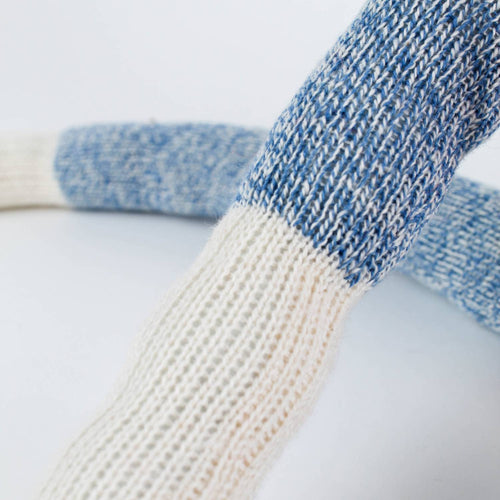 Close-up of the arm of a handcrafted sock monkey made from classic blue and white knit socks, featuring detailed fiberfill stuffing, part of Toys, Books & Games, USA Made, and Children's Toys collections.