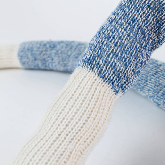 Close-up of the arm of a handcrafted sock monkey made from classic blue and white knit socks, featuring detailed fiberfill stuffing, part of Toys, Books & Games, USA Made, and Children's Toys collections.