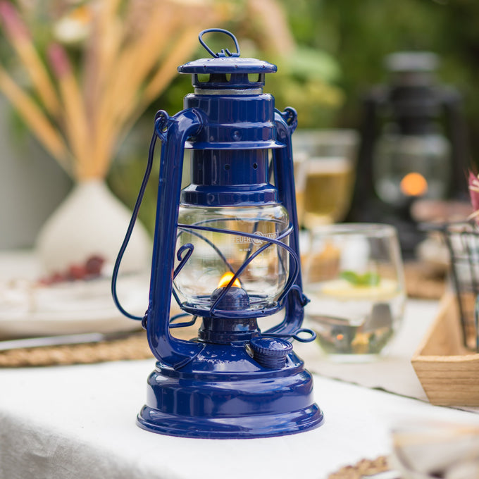 Handcrafted blue galvanized oil lantern with thermal heat-resistant SUPRAX globe, designed for lasting illumination in camping, emergency supplies, and outdoor settings from best sellers collections.