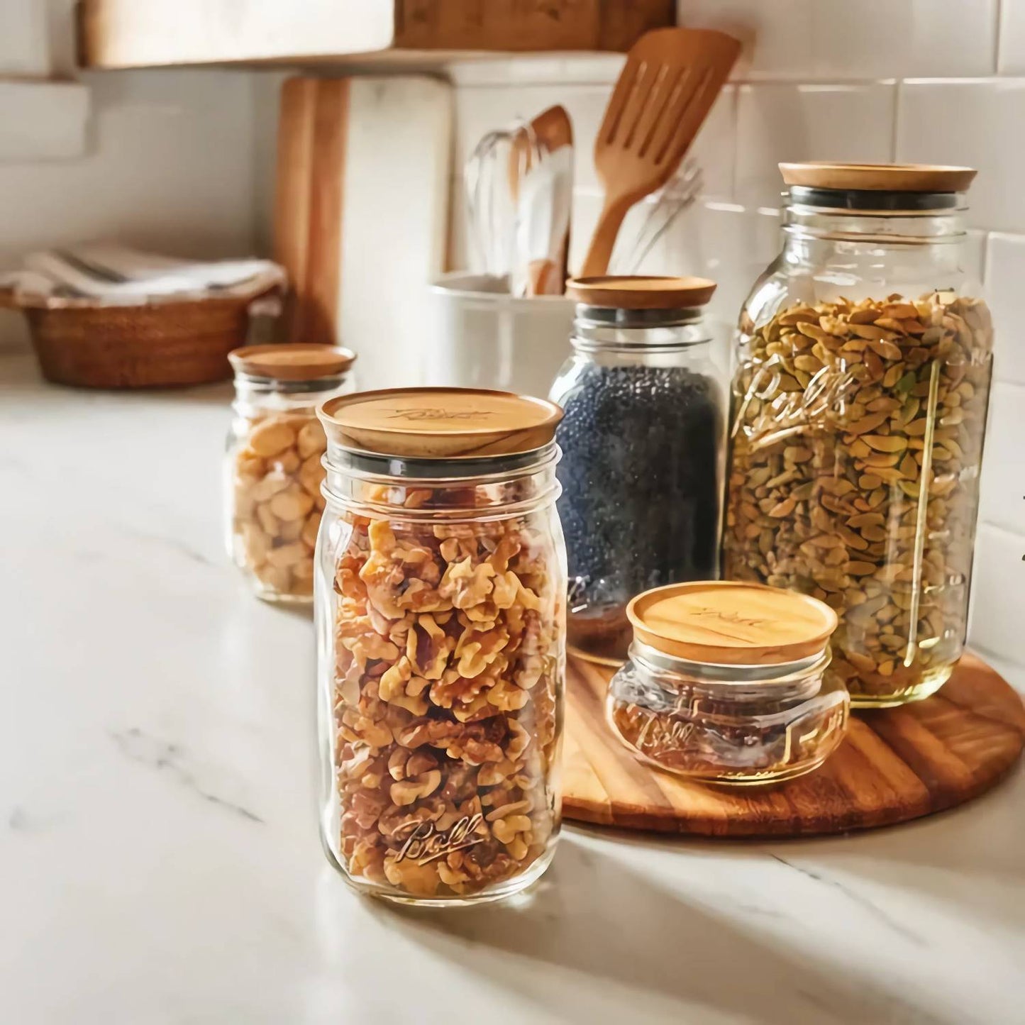 Set of three handcrafted acacia wood airtight lids on various wide mouth glass jars filled with dry pantry foods, styled in a kitchen setting for Storage and Serving, Kitchen & Food collections.