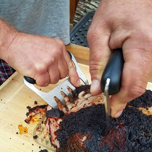 Set of two stainless steel meat shredding claws with black ergonomic handles, shown shredding smoked meat on a wooden cutting board, featured in Kitchen & Food and Kitchen Gadgets collections.