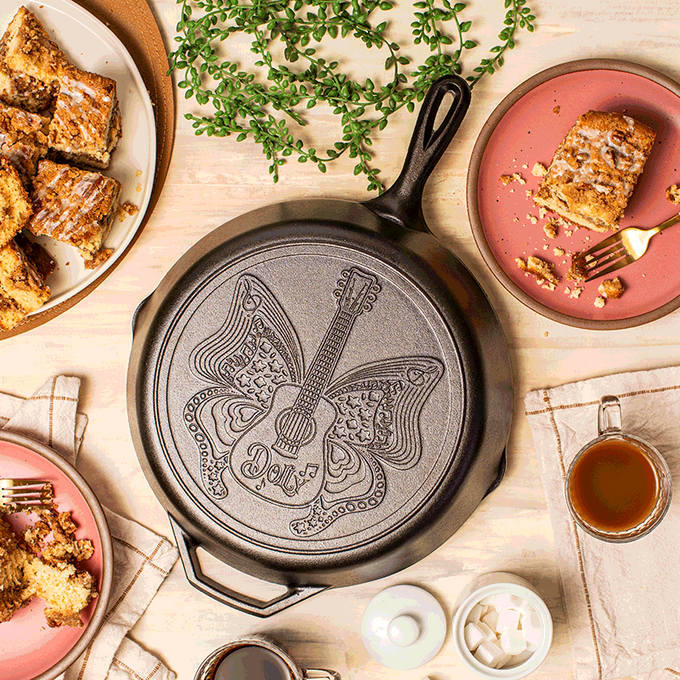 12-inch cast iron skillet featuring an intricate butterfly and guitar design with "Dolly" inscription, handcrafted in USA, ideal for Kitchen & Food, Cookware, Cast Iron, USA Made, Best Sellers, and Promo Eligible collections.