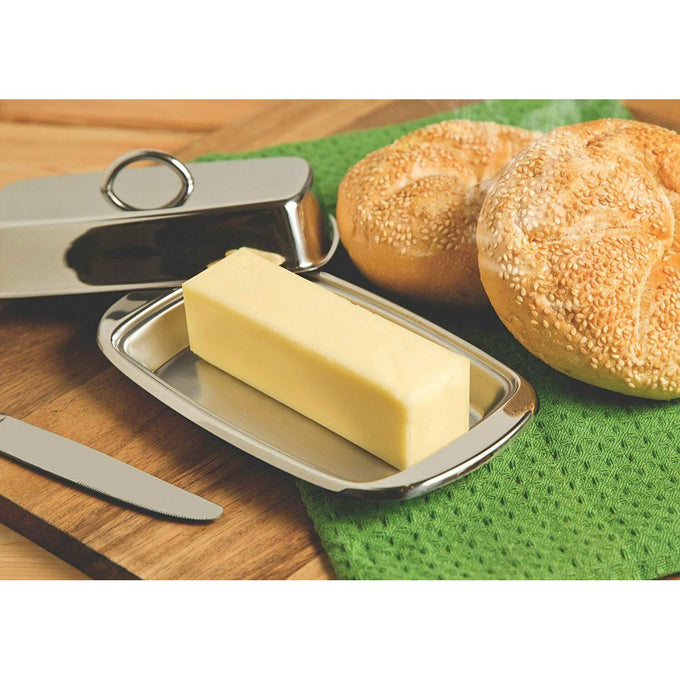 Polished stainless steel butter dish with matching lid holding a full stick of butter, placed on a wooden surface alongside a butter knife and sesame seed rolls, perfect for Kitchen & Food, Specialty Equipment, Making Butter, Storage and Serving, Best Sellers, and Promo Eligible collections.