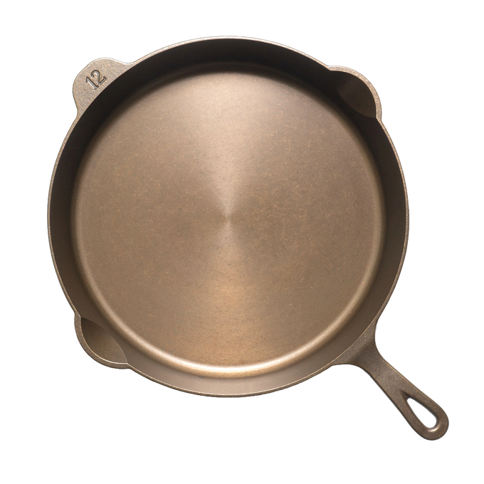 Top view of a handcrafted, lightweight cast iron skillet with smooth cooking surface and a "12" embossed, designed for Farm, Garden & Tool, Kitchen & Food, Camping, Cookware, Cast Iron, USA Made, and Best Sellers collections.