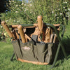 Compact green canvas garden stool with wooden-handled tools in side pockets, designed for comfortable outdoor use and organized gardening, featured in Farm, Garden & Tool collections.