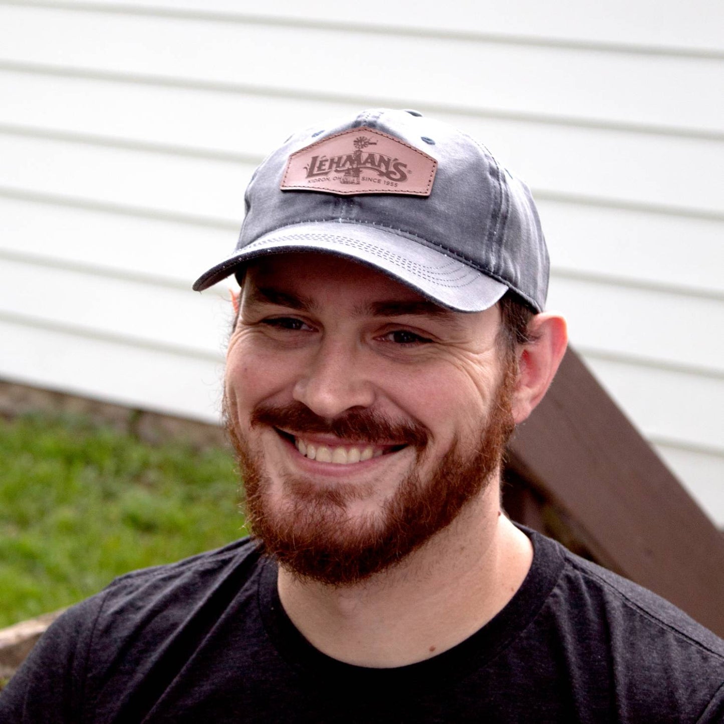 Man wearing a handcrafted vintage-style adjustable hat with a light brown leather patch, featuring a windmill design, ideal for Health & Wellness, Clothing and Accessories, and Best Sellers collections.