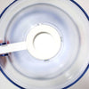 Top-down view of a clear plastic batter dispenser with a white soft grip handle inside, designed for precise and mess-free batter pouring, featured in Kitchen Gadgets and Baking Helpers collections.