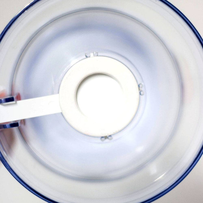 Top-down view of a clear plastic batter dispenser with a white soft grip handle inside, designed for precise and mess-free batter pouring, featured in Kitchen Gadgets and Baking Helpers collections.