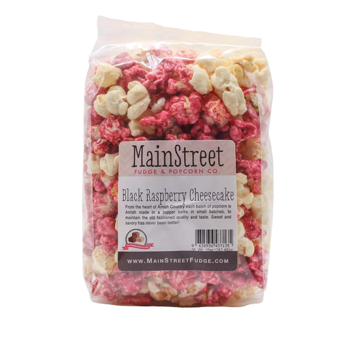 Clear bag of handcrafted popcorn in vibrant white and deep raspberry colors, featuring a sweet and savory black raspberry cheesecake flavor, Amish-made in USA, ideal for Kitchen & Food, Snacks and Sweets, Popcorn, USA Made, Best Sellers, and Promo Eligible collections.