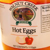 Close-up of Walnut Creek Foods label on a glass jar of hot pickled eggs featuring a red chili pepper illustration and farm landscape, part of USA Made, Kitchen & Food, Pantry, and Best Sellers collections.