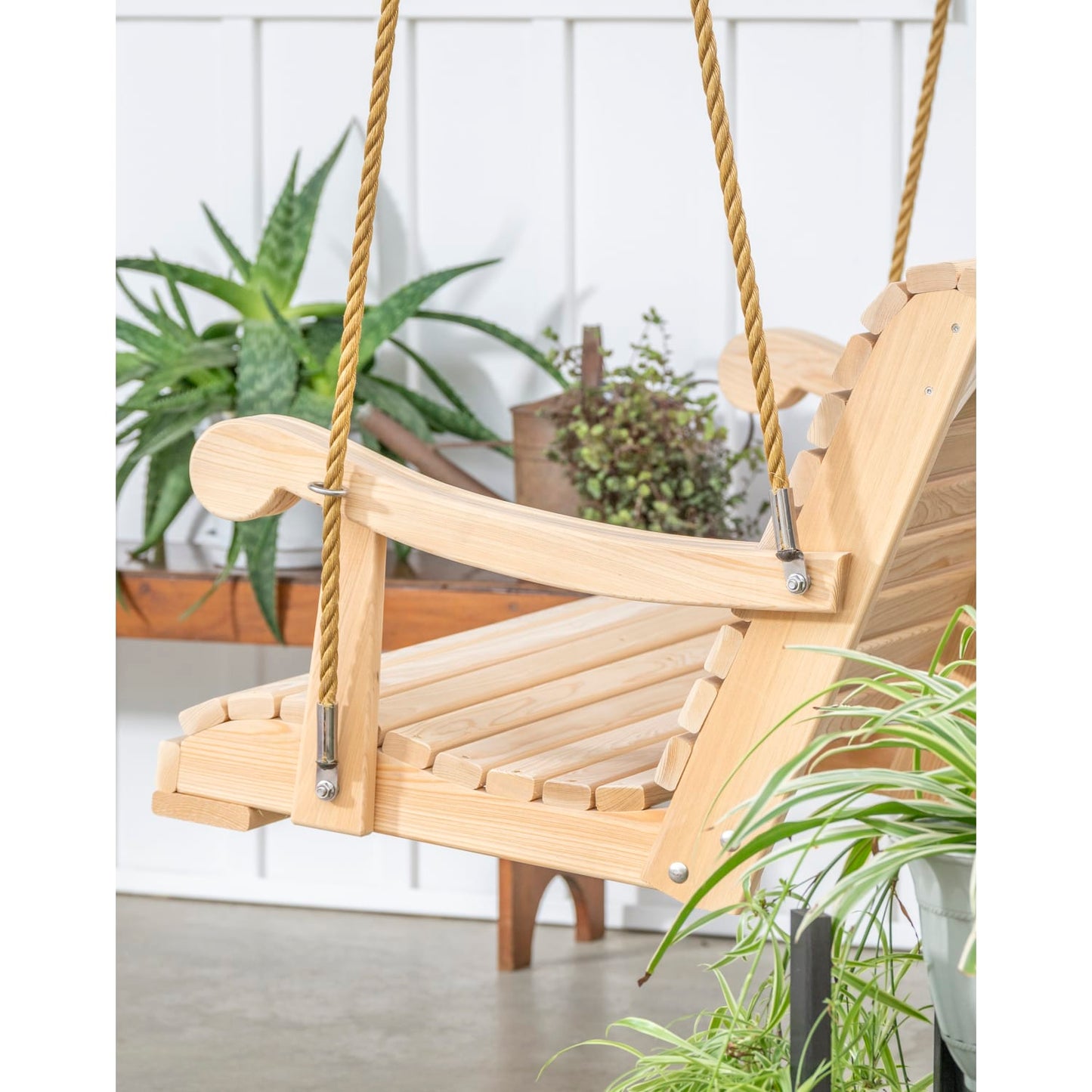 Close-up of handcrafted porch swing featuring durable soft-touch rope and metal hardware, surrounded by green plants, ideal for Home & Decor, Outdoor Furniture, USA Made, Best Sellers, and Promo Eligible collections.