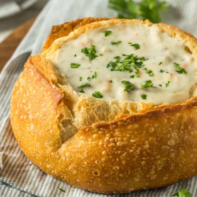 Creamy soup garnished with fresh parsley, served inside a crusty round bread bowl, showcasing a rustic and comforting meal perfect for Kitchen & Food, Dry Goods and Mixes, Soups, USA Made, Best Sellers, Promo Eligible collections.