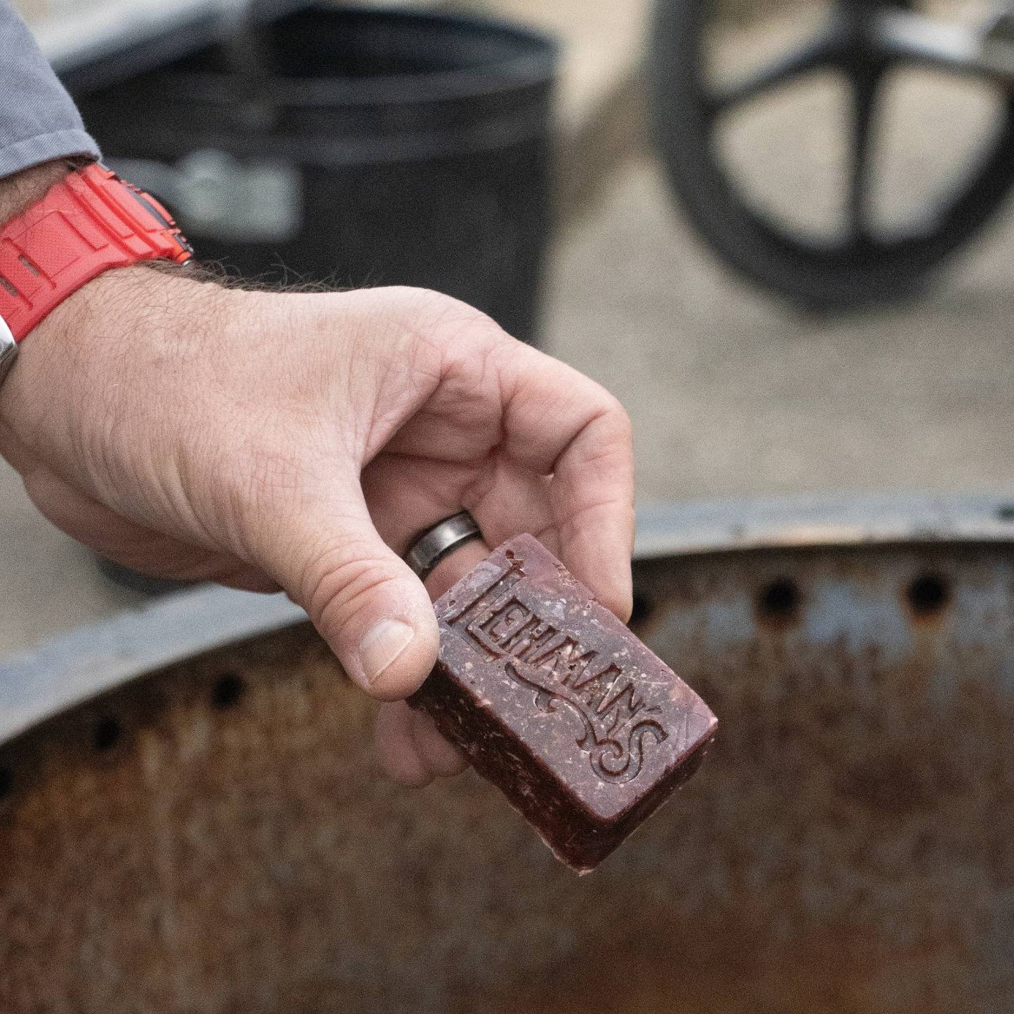 Handcrafted reddish-brown fire starter block embossed with Lehman’s logo, made in the USA from reclaimed wax and sawdust, perfect for Farm, Garden & Tool, Stoves, Camping, and Hearth Accessories.