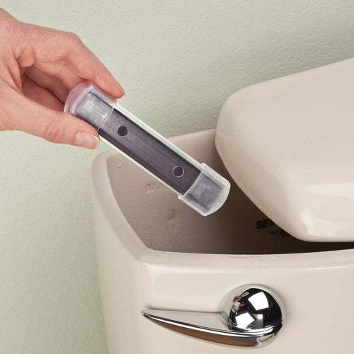 Hand holding a clear plastic magnet housing designed to prevent mineral stains, being placed inside a beige toilet tank, featured in Home & Decor and Household Cleaning collections.