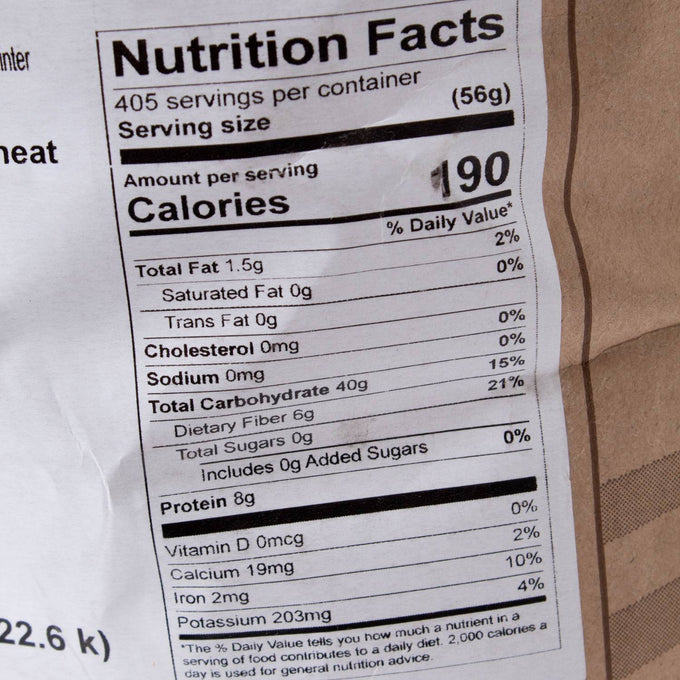 Close-up of nutrition facts label on a 50 lb bag of Hard Red Winter Wheat showing calories, fat, carbohydrates, protein content, and minerals, featured in Pantry, Food, and USA Made collections.