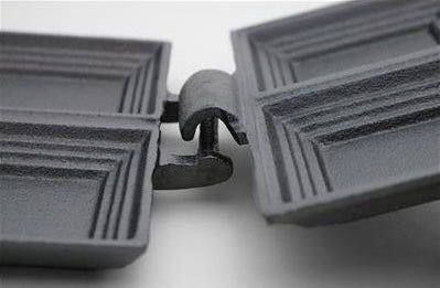 Close-up of the handcrafted cast iron double pie iron hinge showing the open design and sturdy construction, designed for easy cleaning and outdoor campfire use in Farm, Garden & Tool and Camping collections.