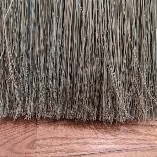 Close-up view of tightly hand-bound natural corn straw bristles on a large Amish made broom, ideal for farmhouse and household cleaning tasks, crafted in the USA.
