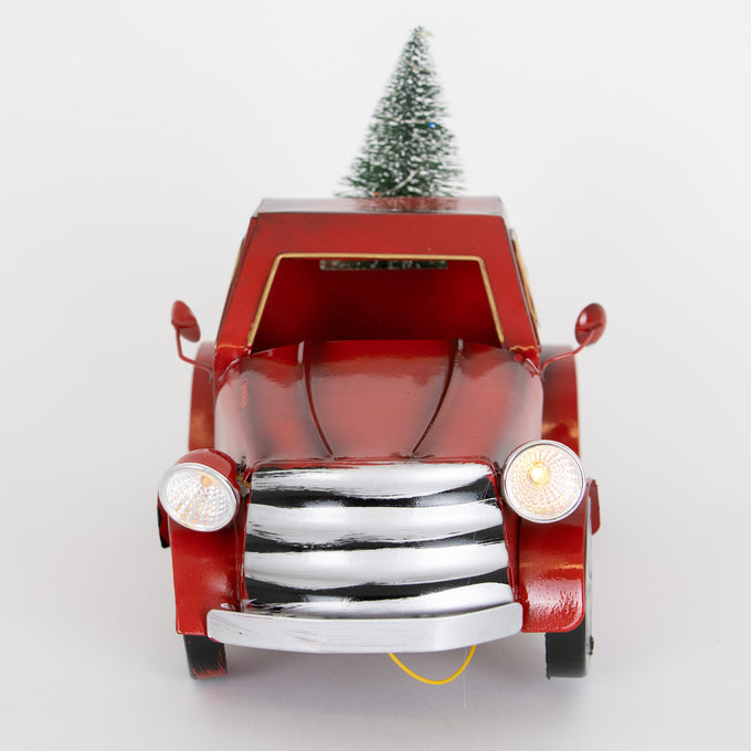 Handcrafted red metal holiday truck with illuminated headlights carrying a small frosted green tree, perfect for Home & Decor, Holiday Decor, and Best Sellers collections.