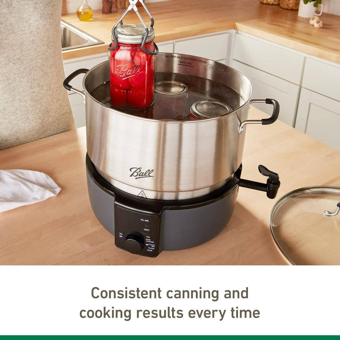 Stainless steel electric water bath canner with digital control and spigot, lifting a sealed jar of red preserves for food preservation in Kitchen & Food collections.