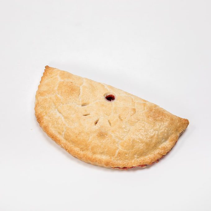 Generously sized golden-brown turnover with a flaky crust and decorative vents, showcasing a handcrafted treat from USA Made, Kitchen & Food, Snacks and Sweets, and Best Sellers collections.