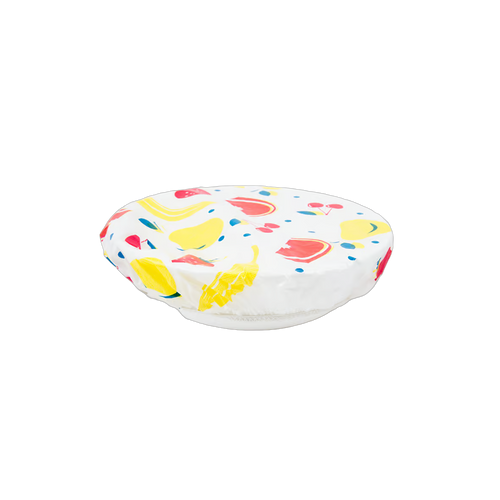 Colorful reusable bowl cover with elastic band securing a fruit-patterned plastic cover over a glass bowl, featured in Kitchen & Food, Storage and Serving, and Best Sellers collections.