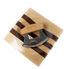 Handcrafted ulu knife with crescent-shaped stainless steel blade and wooden handle resting on a striped wooden chopping bowl, ideal for food prep and kitchen gadgets collections.