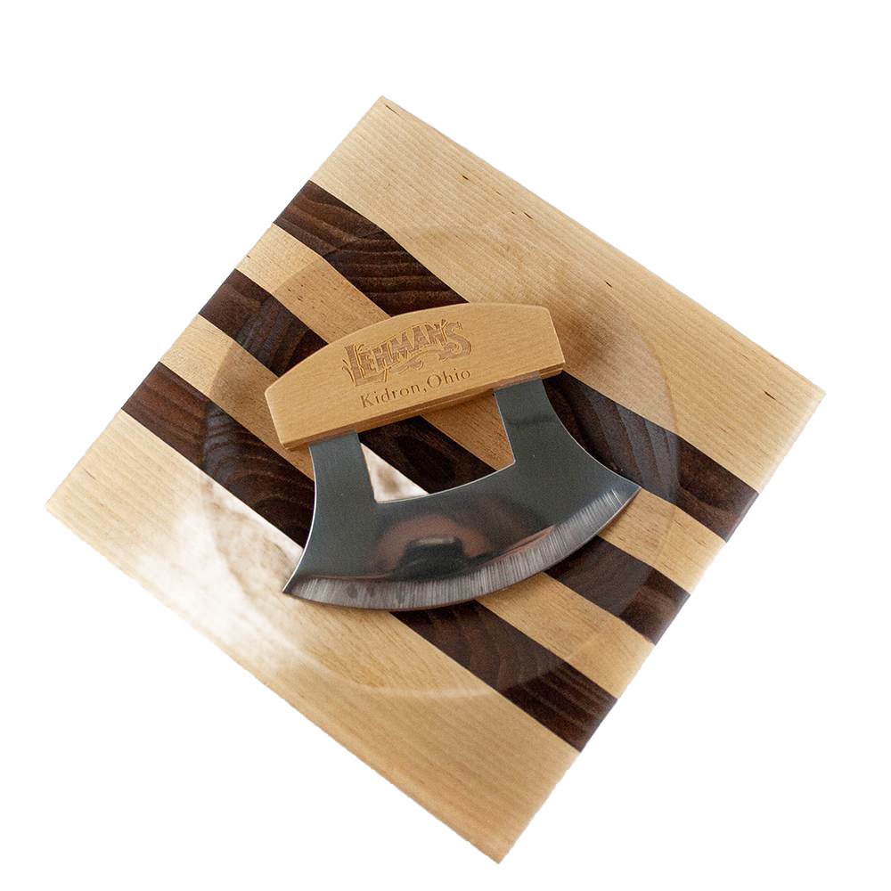 Handcrafted ulu knife with crescent-shaped stainless steel blade and wooden handle resting on a striped wooden chopping bowl, ideal for food prep and kitchen gadgets collections.