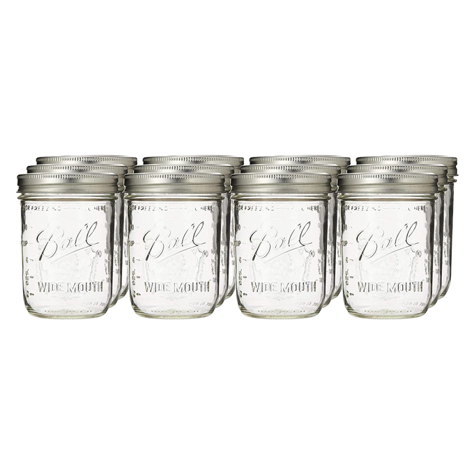 Set of 12 clear wide-mouth pint jars with metal lids, handcrafted and made in USA, perfect for food preservation, kitchen storage, canning, and crafting projects.