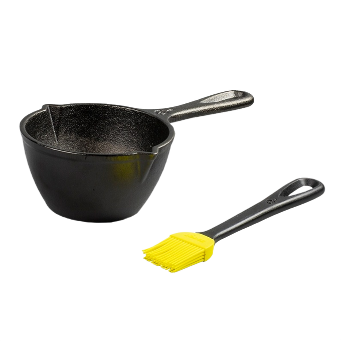 Black cast iron melting pot with a handle, accompanied by a black brush with yellow silicone bristles, designed for even heat retention, ideal for Kitchen & Food and Cast Iron collections.