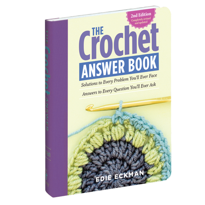 Soft yellow and purple cover of a crocheting guidebook featuring a partially completed round crochet motif in blue, green, and yellow yarn with a gold crochet hook, included in Sewing and Quilting, Home & Decor, Toys, Books & Games, and Best Sellers collections.