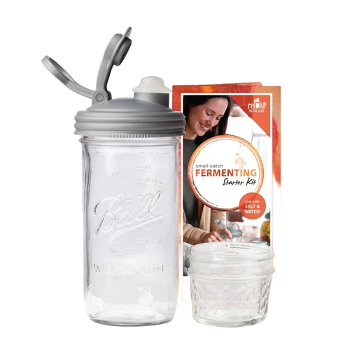 Clear wide-mouth mason jar with a gray fermentation lid and airlock plug, accompanied by packaging featuring a smiling woman, ideal for Kitchen & Food, Food Preservation, and USA Made collections.