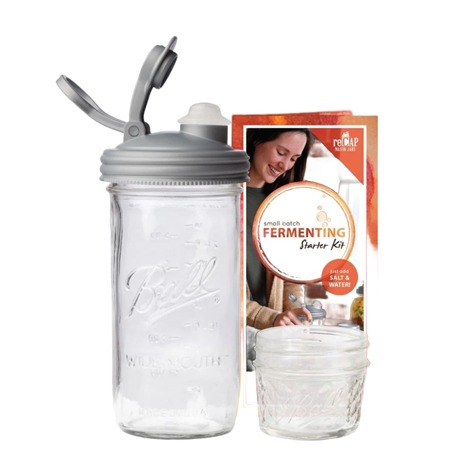 Clear wide-mouth mason jar with a gray fermentation lid and airlock plug, accompanied by packaging featuring a smiling woman, ideal for Kitchen & Food, Food Preservation, and USA Made collections.