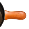 Handcrafted American vegetable-tanned leather handle cover with embossed wagon design, protecting hands from heat on cast iron skillets, ideal for Kitchen & Food and USA Made collections.