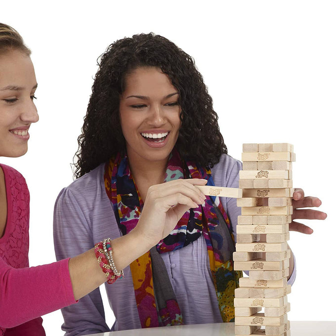 Two women playing a classic wooden block stacking game on a white table, showcasing family-friendly strategy and skill in Toys, Books & Games, Children's Toys, and Table and Board Games collections.