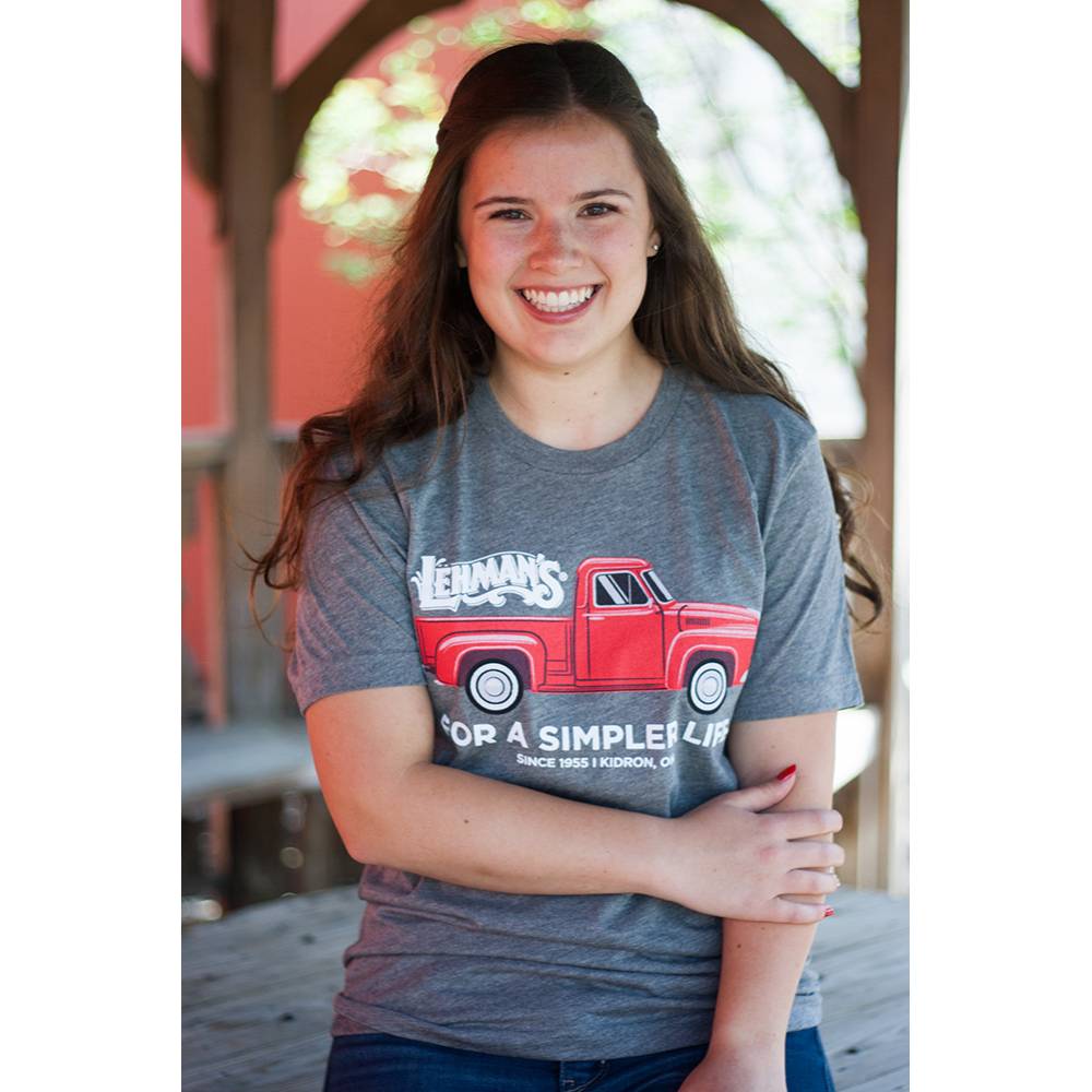 Adult wearing a light gray soft cotton t-shirt with a bright red vintage truck graphic and "For a Simpler Life" text, part of Lehman's best-selling clothing and accessories collection.
