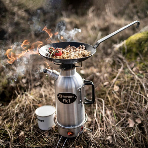 Hand-forged wrought iron pan cooking a hearty meal with tomatoes and beans over a portable stove outdoors, perfect for Farm, Garden & Tool, Kitchen & Food, Camping, Cookware, and Best Sellers collections.