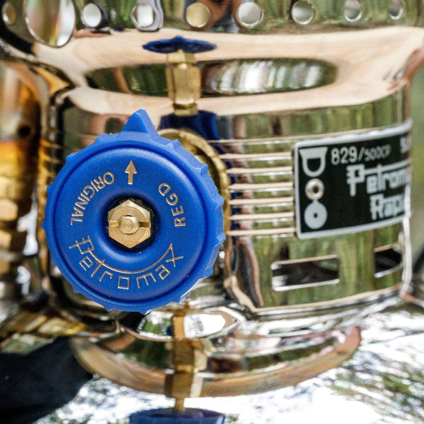 Close-up of a polished metal carburetor knob in blue with clear embossed lettering, part of a high-quality pressure lamp accessory featured in Lamps & Lighting and Parts collections.