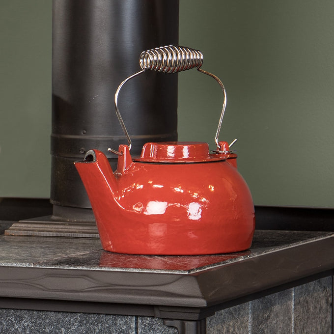 Durable cast iron red kettle steamer with enamel finish and coiled metal handle, designed for wood stove use, featured in Stoves, Hearth Accessories, Best Sellers, and Promo Eligible collections.