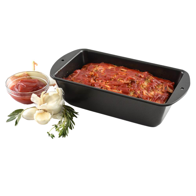 Black non-stick loaf pan with pierced inner tray for fat drainage, shown with a cooked meatloaf topped with tomato sauce, alongside fresh garlic, rosemary, and a bowl of sauce, ideal for Kitchen & Food, Cookware, Baking Supplies, Best Sellers, and Bread Making Supplies collections.