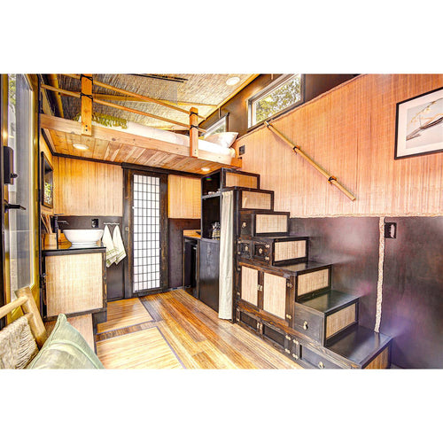 Interior view of a handcrafted tiny house featuring wood and woven natural materials, compact kitchen, built-in staircase with storage, and cozy loft bed, perfect for Home and Garden How-To Books and Toys, Books & Games collections.