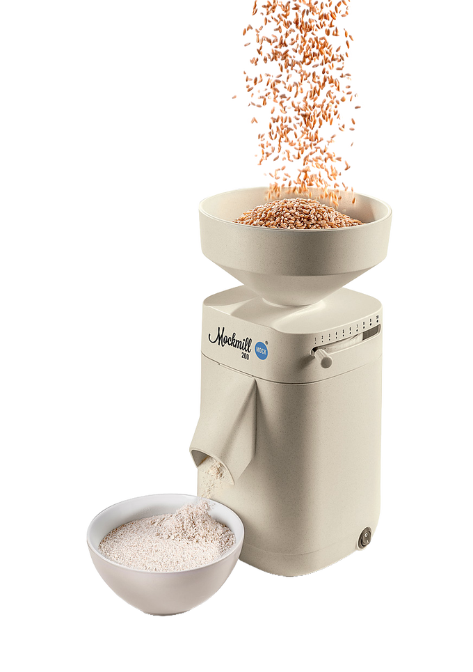 Electric grain mill with a beige finish grinding wheat into fresh flour, featuring a top hopper and bowl below, perfect for Kitchen & Food and Grain Mills collections.