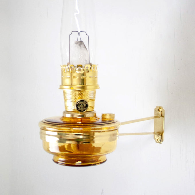 Handcrafted amber glass wall oil lamp with polished brass burner and clear chimney, made in USA, ideal for Farm, Garden & Tool, Lamps & Lighting, Emergency Supplies, and Wall Lamps collections.